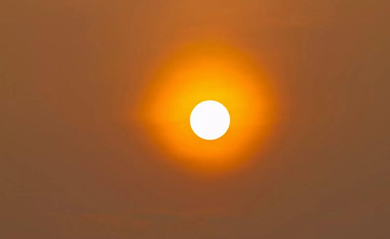 Large orange sun in the sky