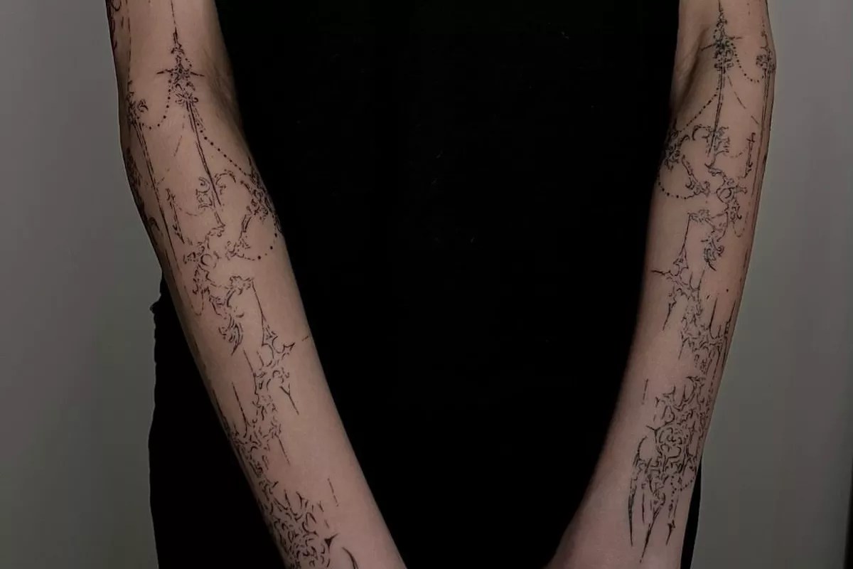 Arms tattooed with a cybersigilism design