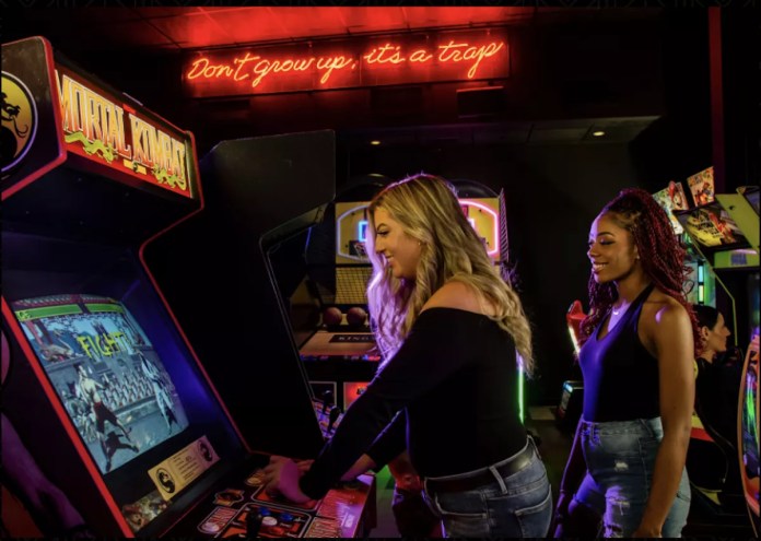 Two women playing arcade games at Kings Dining & Entertainment