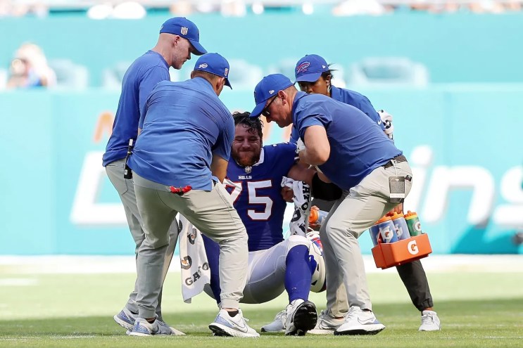 Greg Van Roten #75 of the Buffalo Bills is attended to by team staff during the fourth quarter against the Miami Dolphins at Hard Rock Stadium on September 25, 2022 in Miami Gardens, Florida