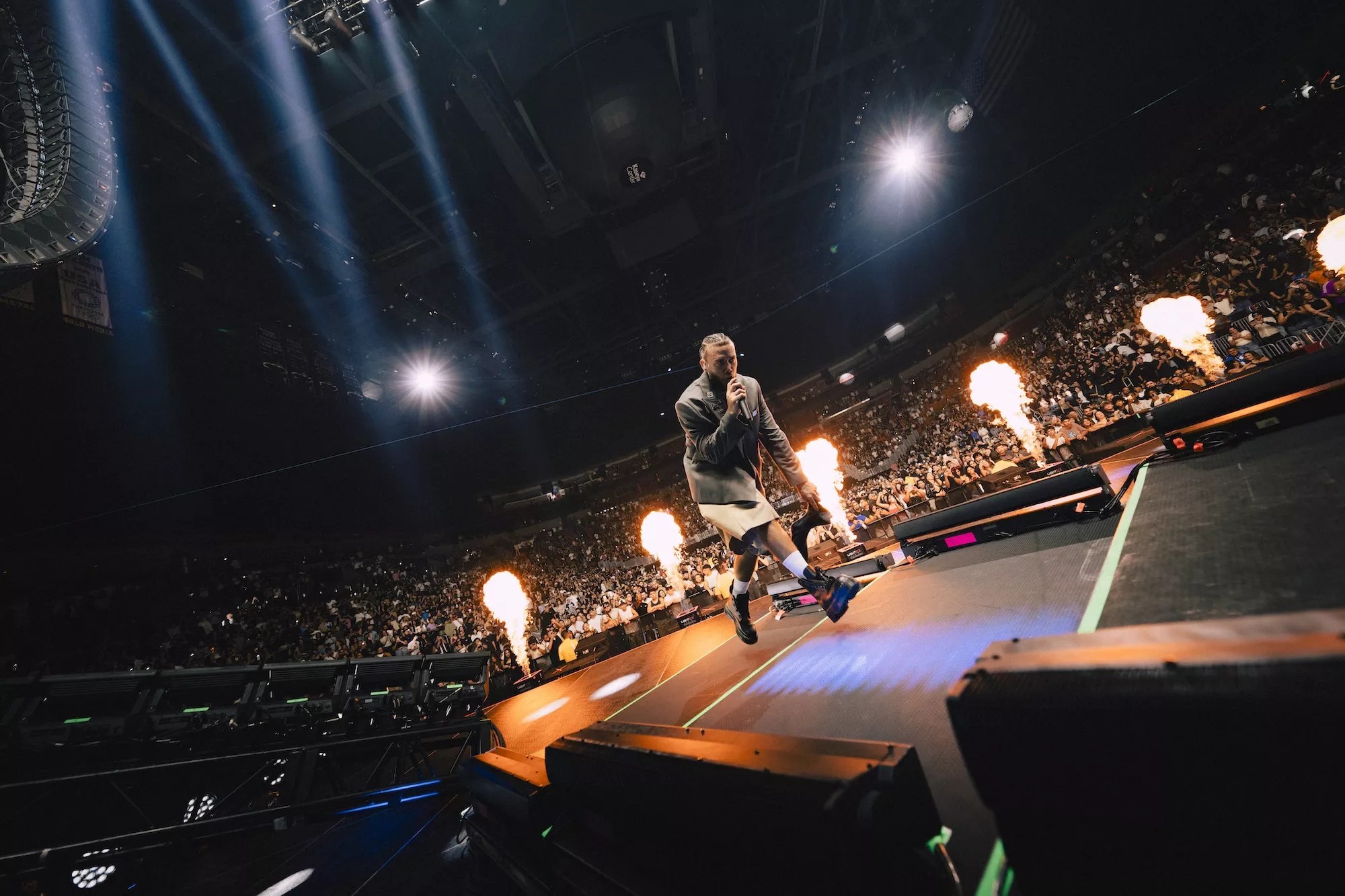 Jhayco performing onstage at the Kaseya Center in Miami