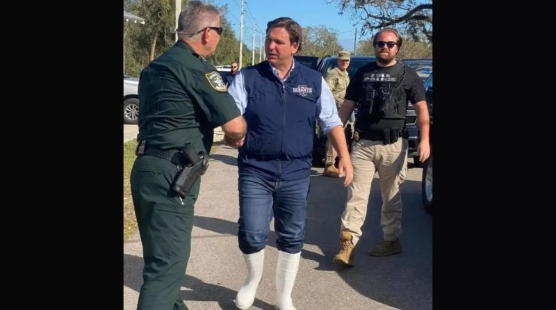 Ron DeSantis wears his white knee-high rubber boots while visiting Florida's west coast during Hurricane Ian recovery efforts in 2022.