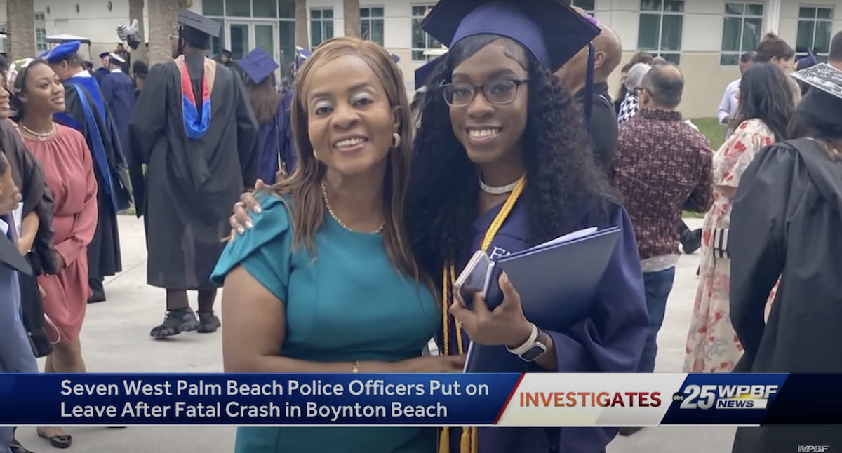 A woman stands next to her daughter, who is donning a cap and gown on graduation day.
