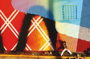 The artist Momo works on a mural in 2012.