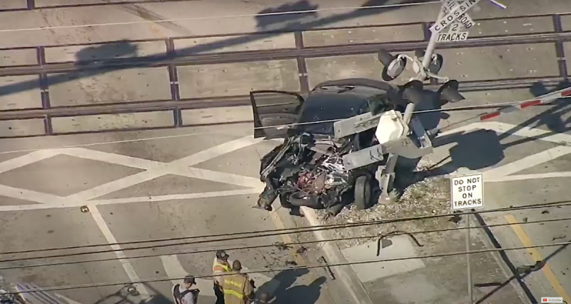 A wrecked car that was just hit by a Brightline train.