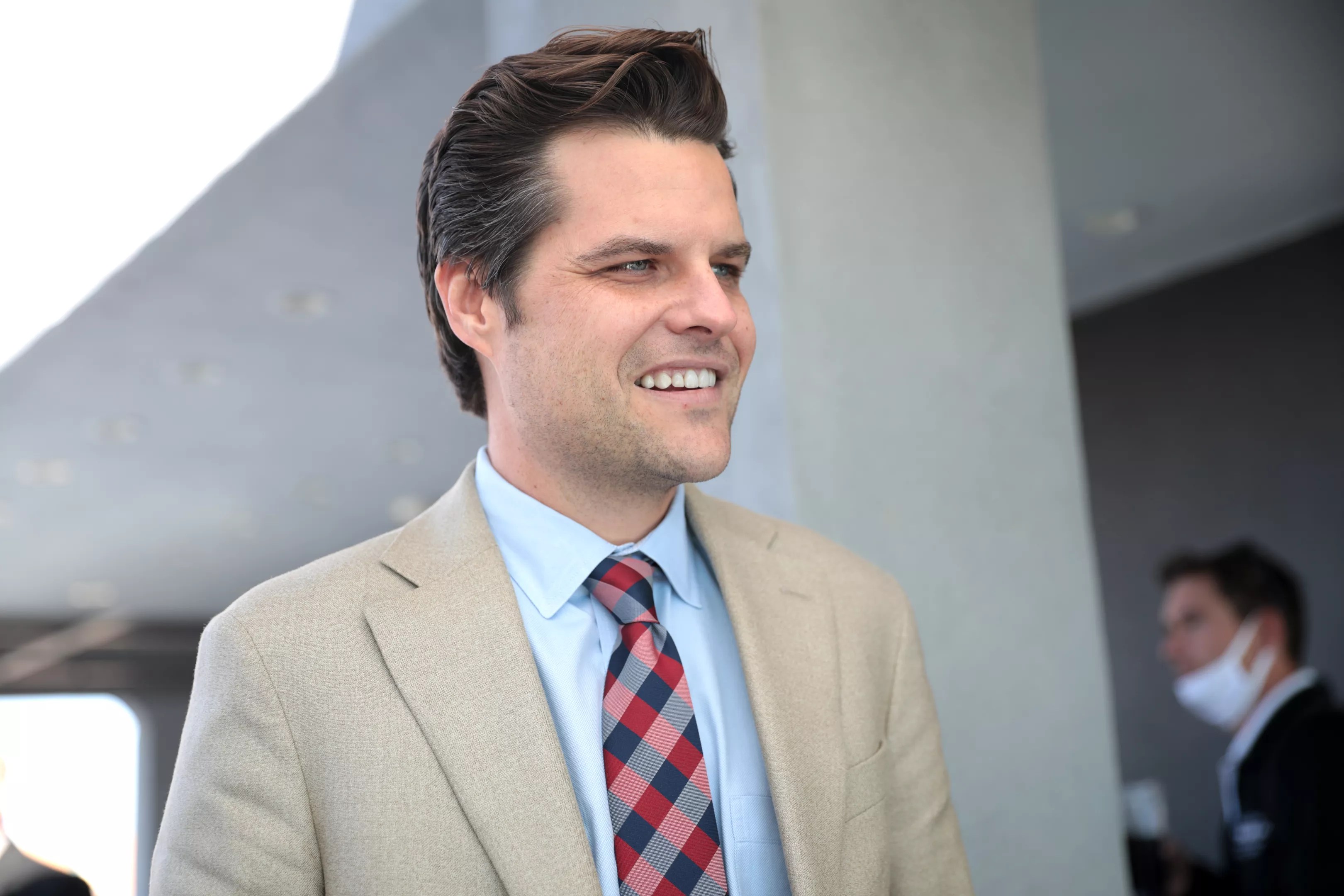 Matt Gaetz looking away from camera smiling.