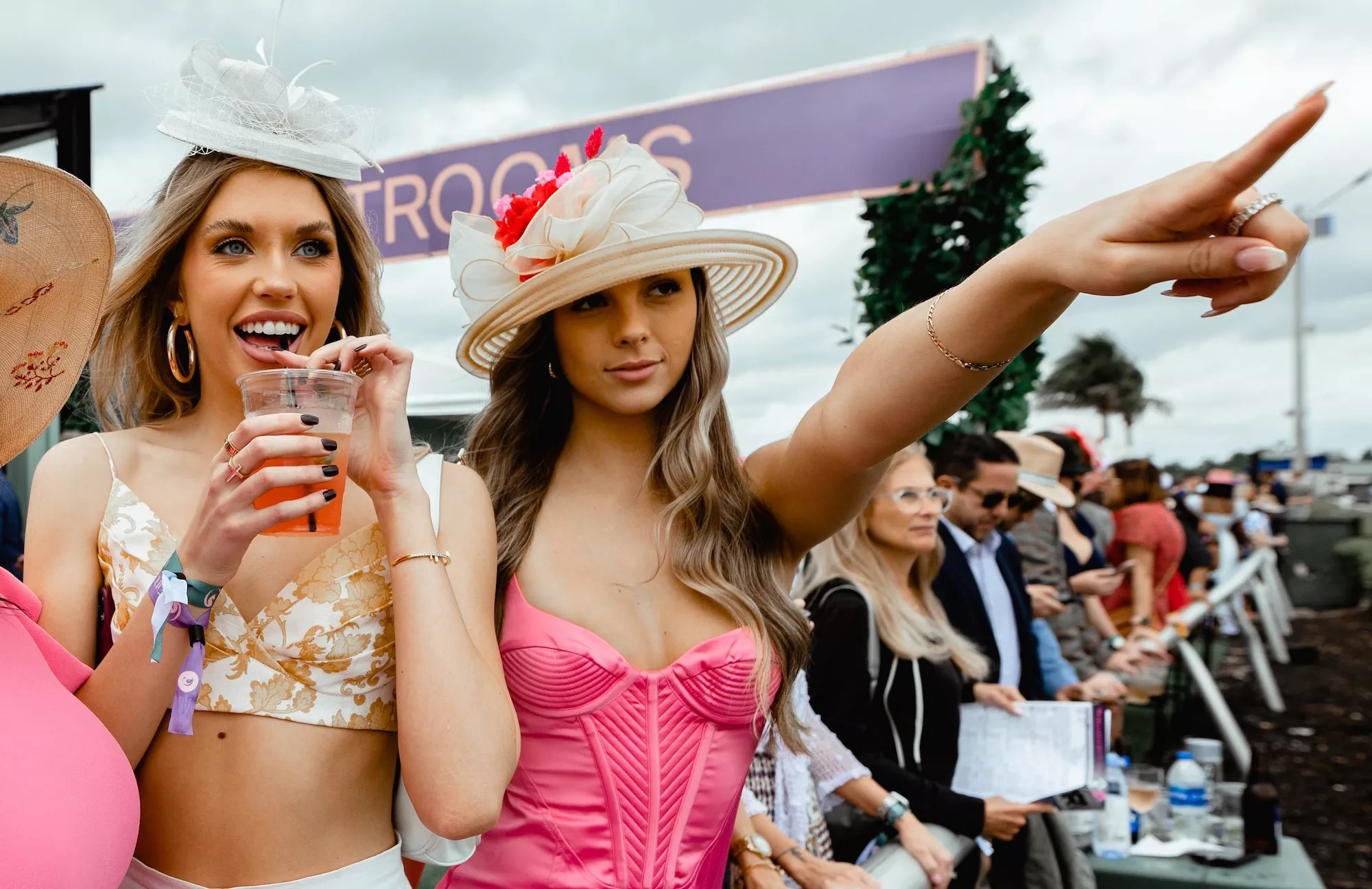 Two women standing trackside at the Pegasus World Cup in Hallandale Beach, Florida