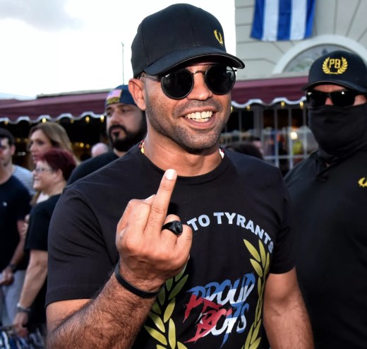 Photo of then-Proud Boys leader Enrique Tarrio flipping his middle finger at the photographer.