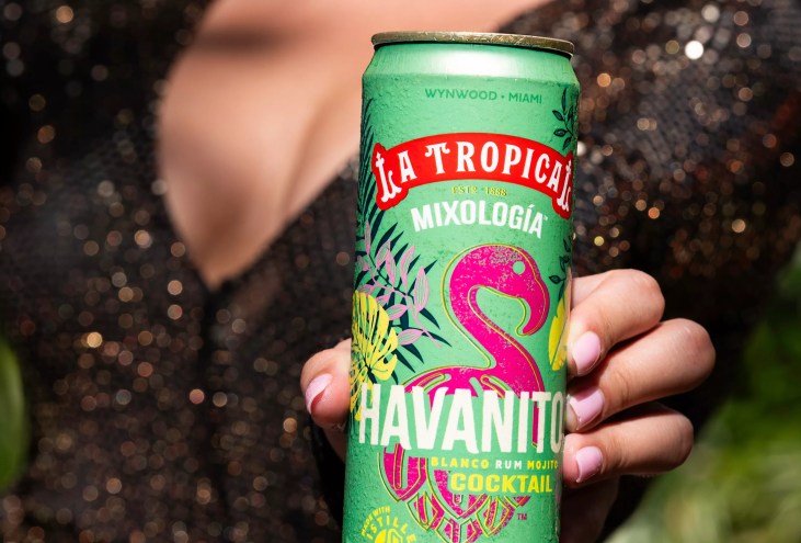 woman holding can of beer