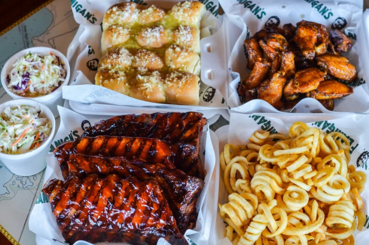 fries, baby back ribs, and bread on a table