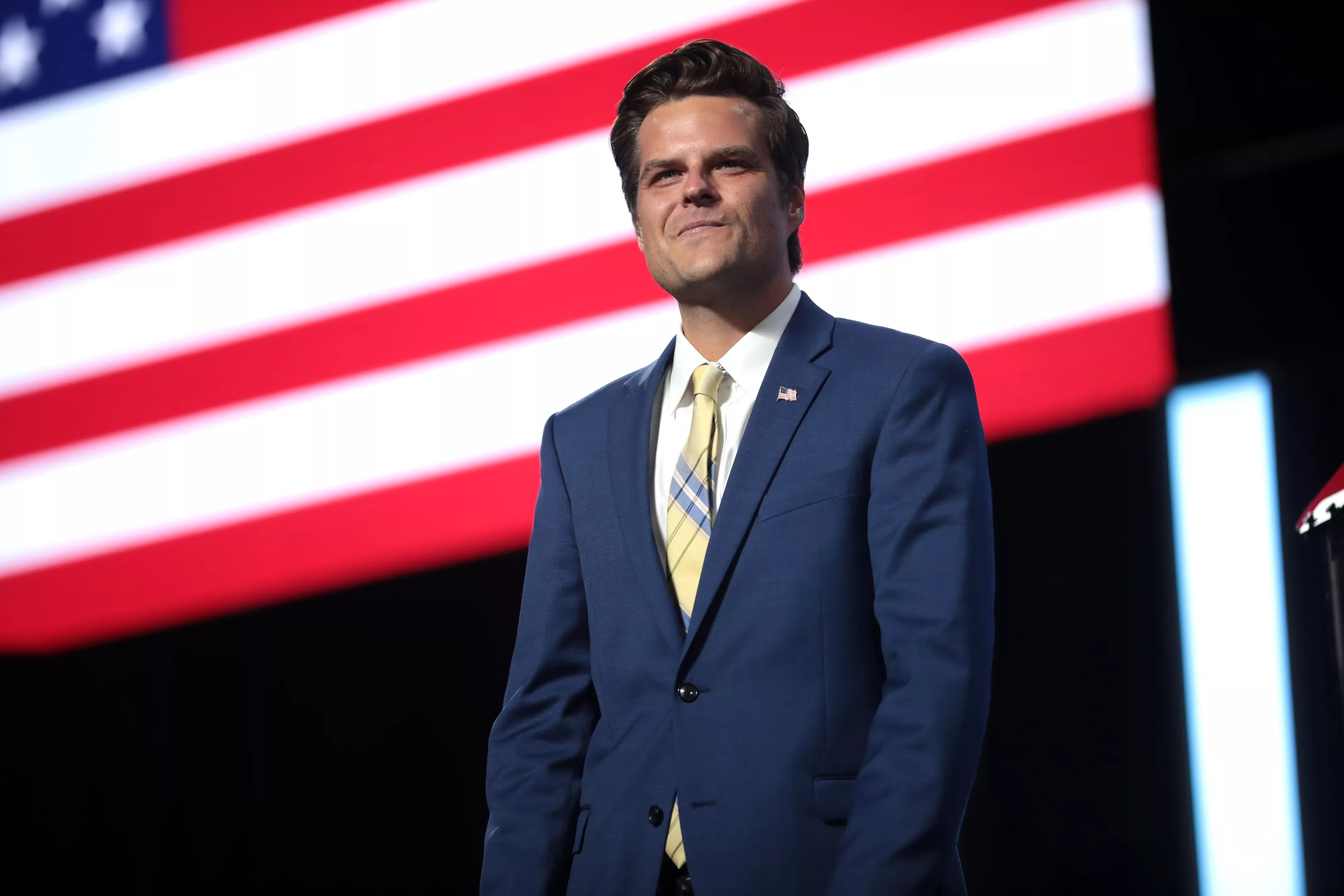Matt Gaetz stands on stage