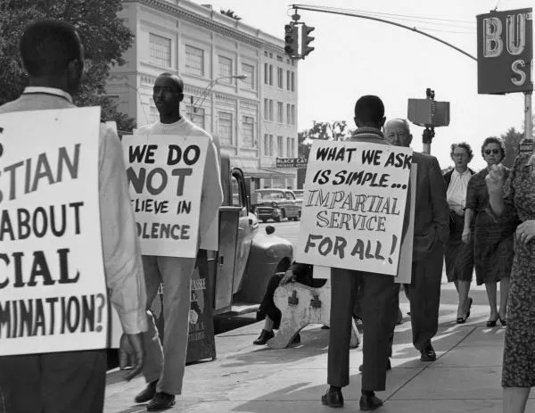 People hold signs to picket downtown stores in 1960 Tallahassee.