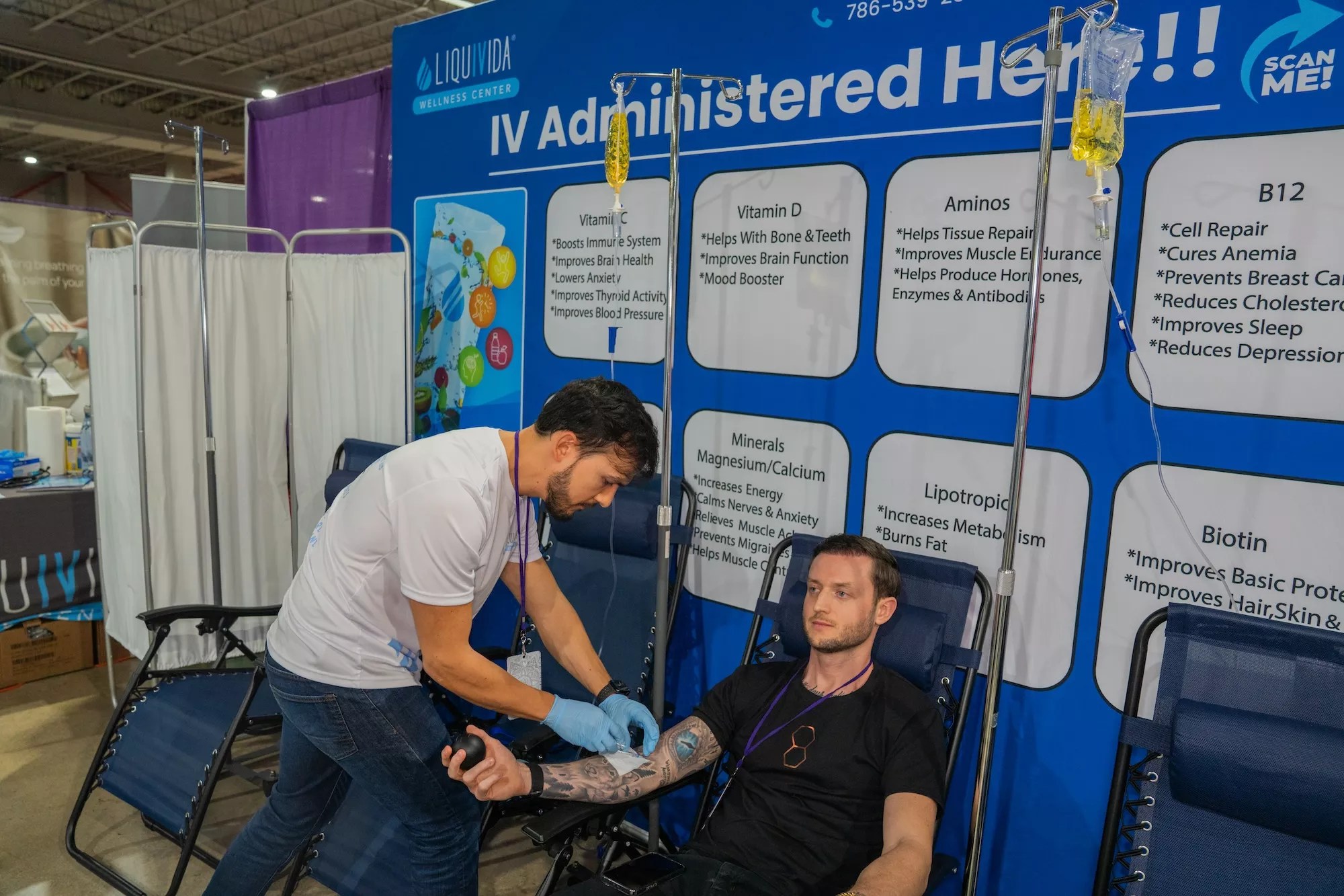 a man administers IV treatment to another man