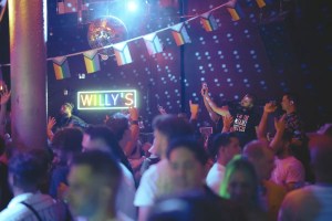 People dancing inside of Willy's Neighborhood Bar in Wynwood
