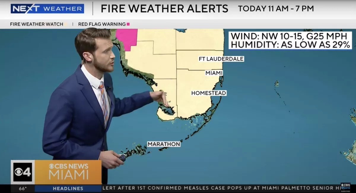 A photo of a meteorologist in front of a map showing the Fire Weather Watch across South Florida.