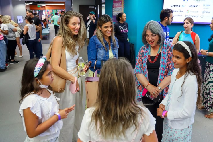 a group of women and girls converse in a circle at Miami's Code/Art Fest