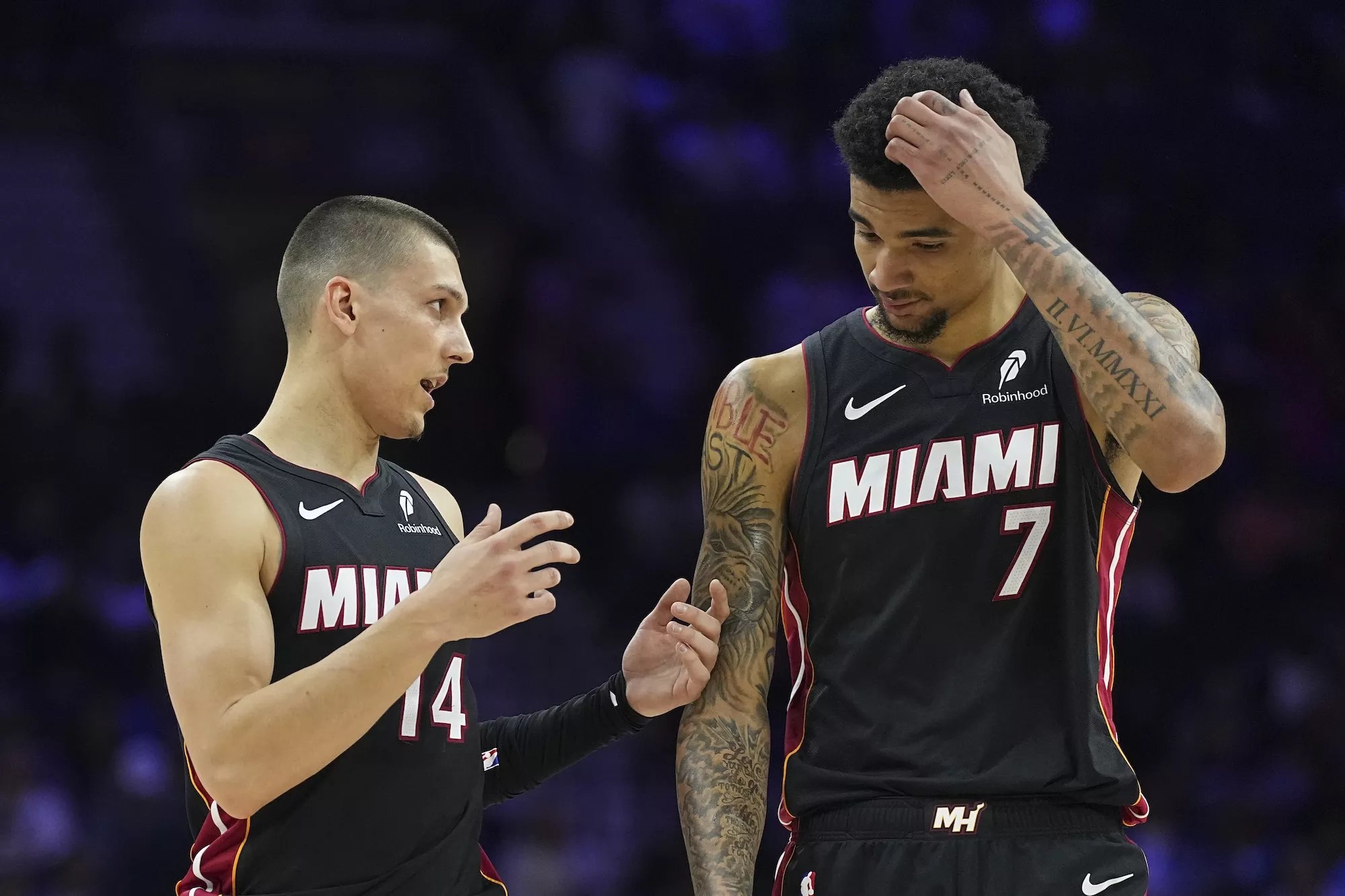 Tyler Herro #14 of the Miami Heat talks to Kel'el Ware #7 against the Philadelphia 76ers in the first half at the Wells Fargo Center on March 29, 2025, in Philadelphia, Pennsylvania.