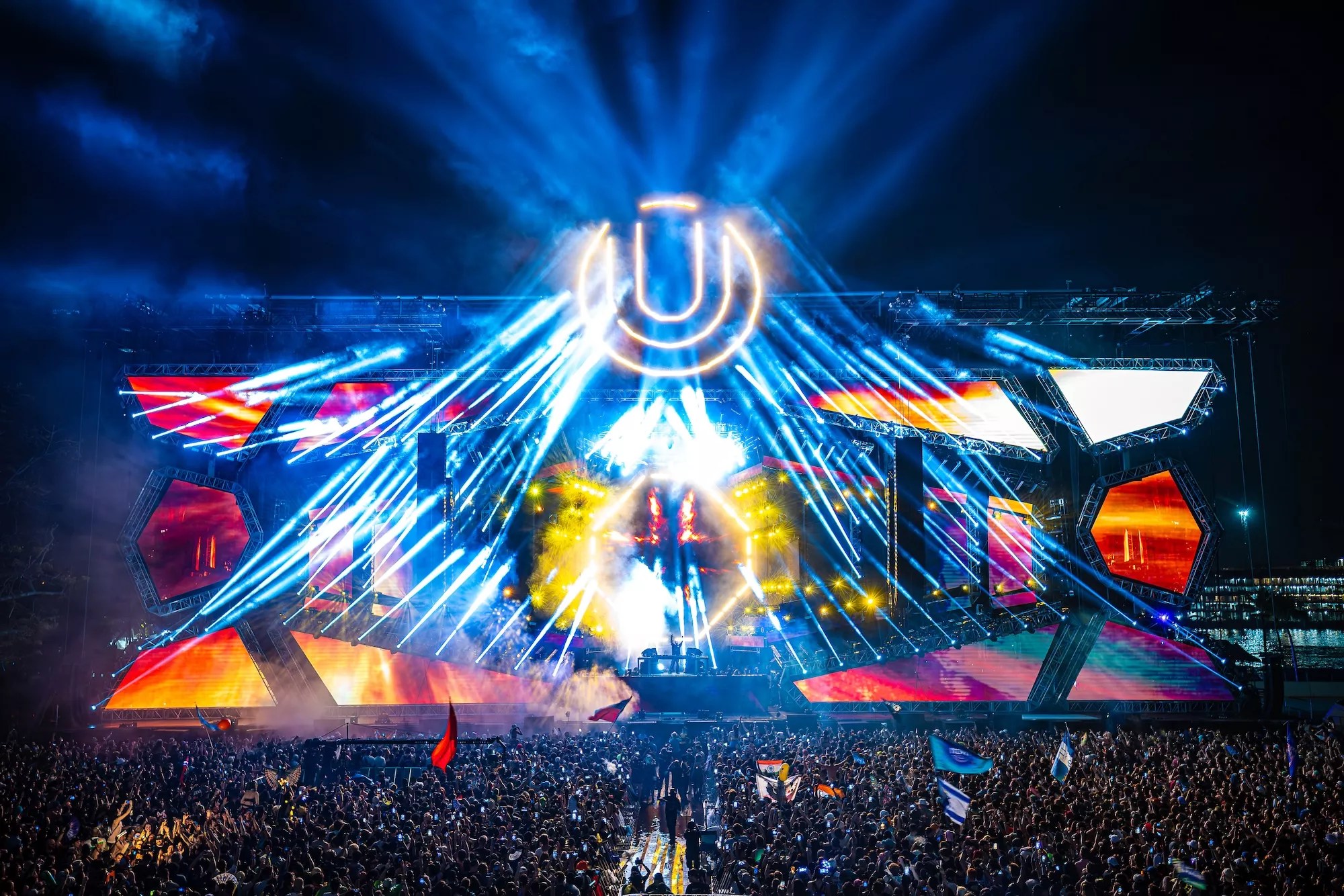 Photo of a stage with colorful LED lights and a u shaped logo.