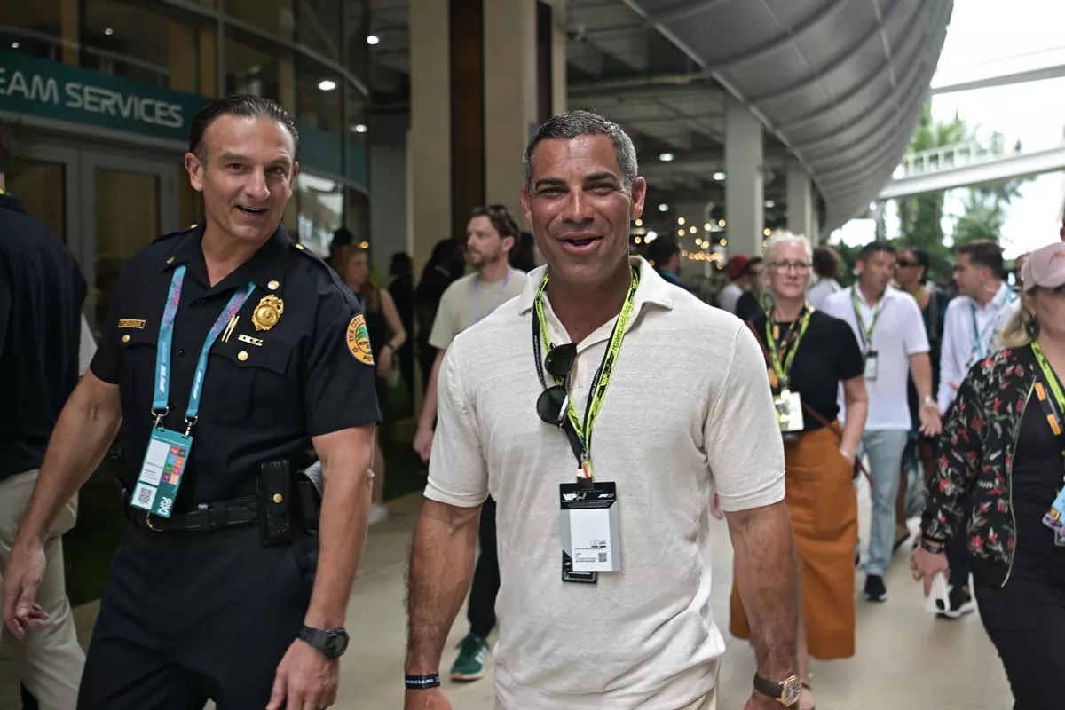 Miami Mayor Francis Suarez walking in the paddock with a city of Miami police officer at the 2025 Miami Grand Prix.