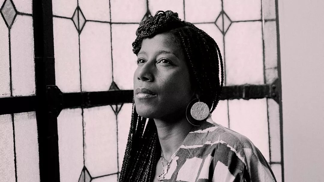 a sepia-toned headshot of poet Aja Monet