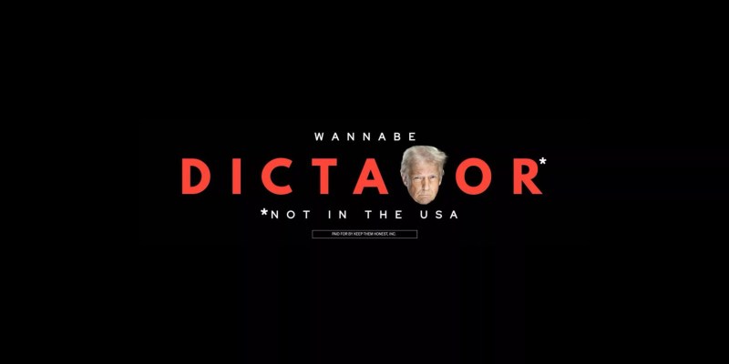 A billboard calls President Donald Trump a "Wannabe Dictator" with a photo of Trump as the second "t".