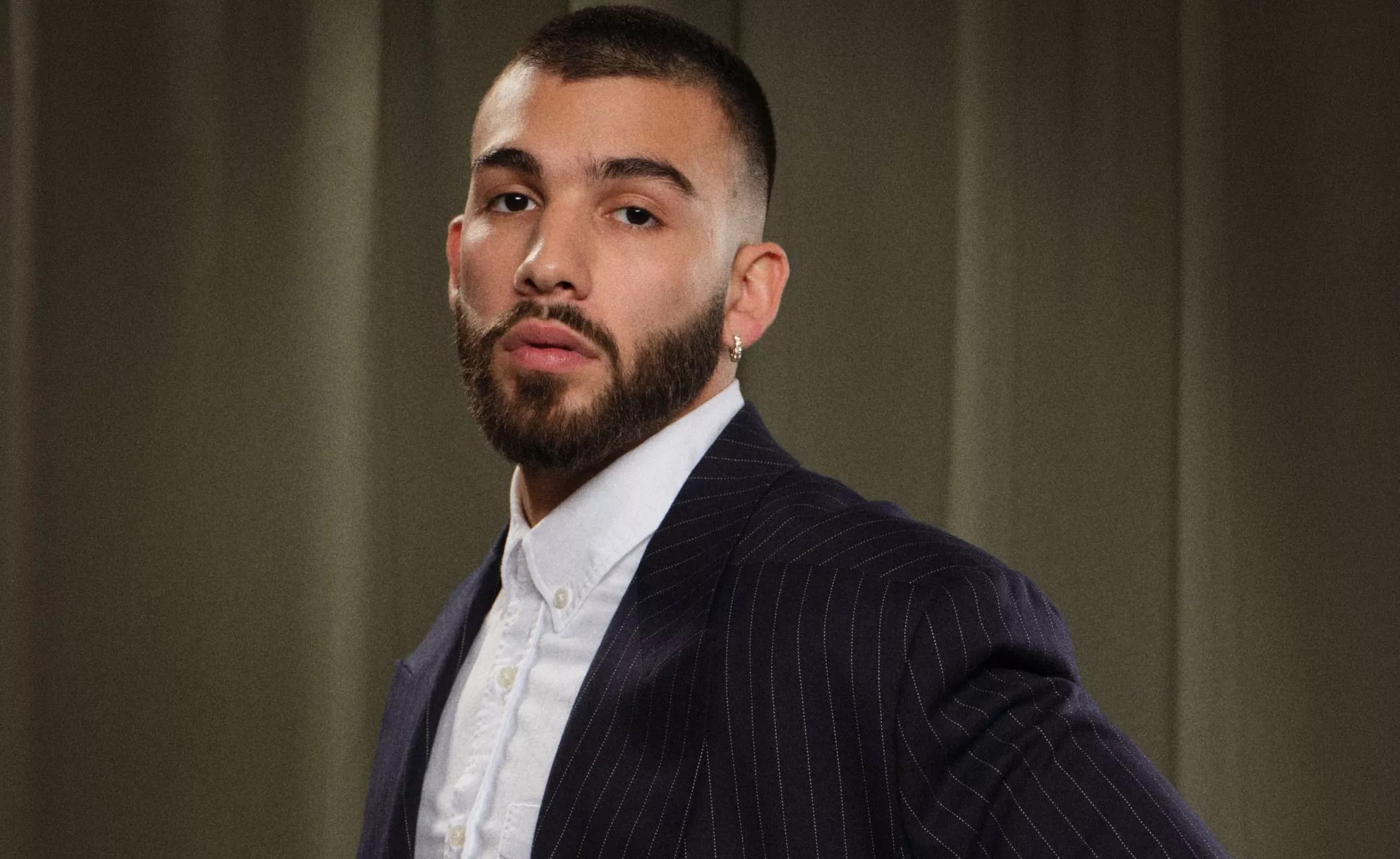 headshot of Manuel Turizo wearing a dress shirt and blazer