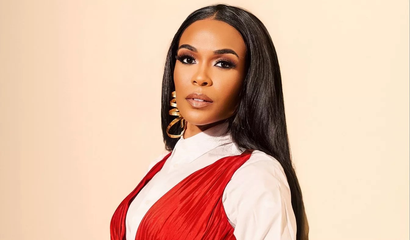 headshot of singer Michelle Williams in a red and white outfit