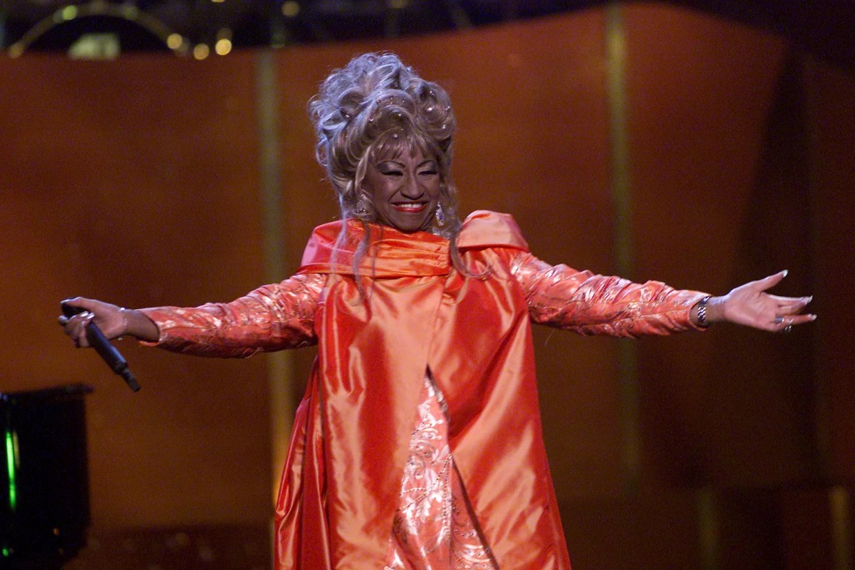 Celia Cruz on stage wearing a red dress