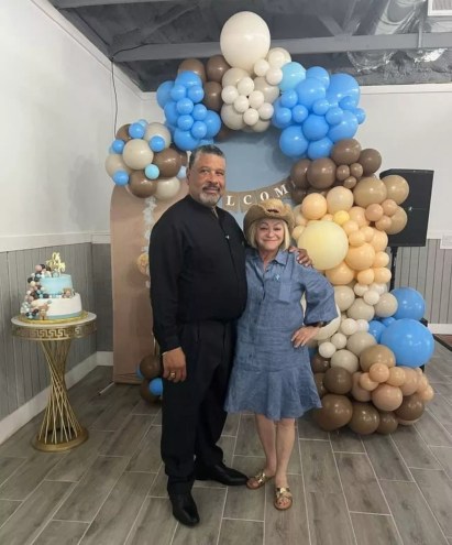 Sonia Bichara (right) and Rafael Collodo pose for a picture in front of balloons