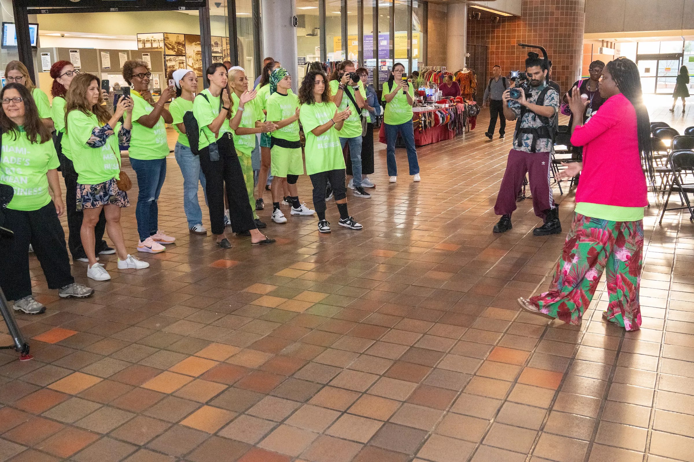 protesters in lime-green t-shirts gather at a train station