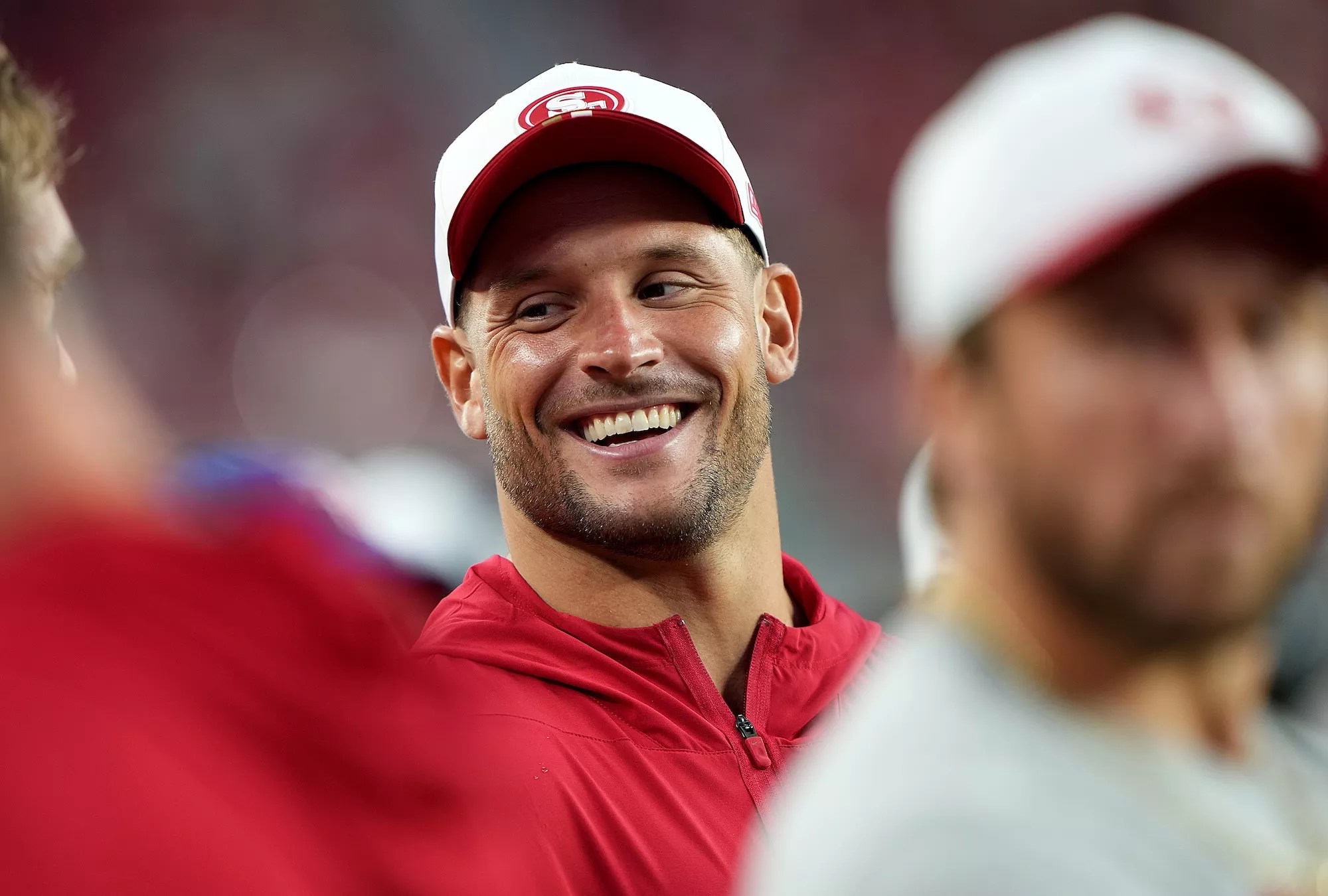 Nick Bosa of the San Francisco 49ers, clad in athleisure gear, looks on from the sidelines against the Denver Broncos in the second half during the NFL preseason game at Levi's Stadium on August 09, 2025, in Santa Clara, California.