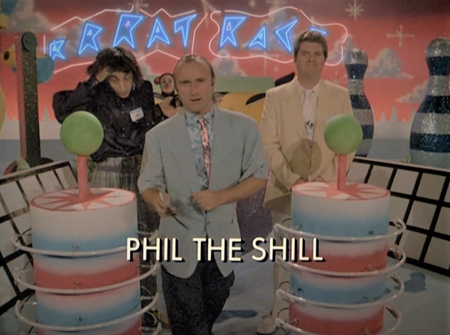 A Miami Vice scene featuring Phil Collins, Emo Philips, and Michael Talbott.
